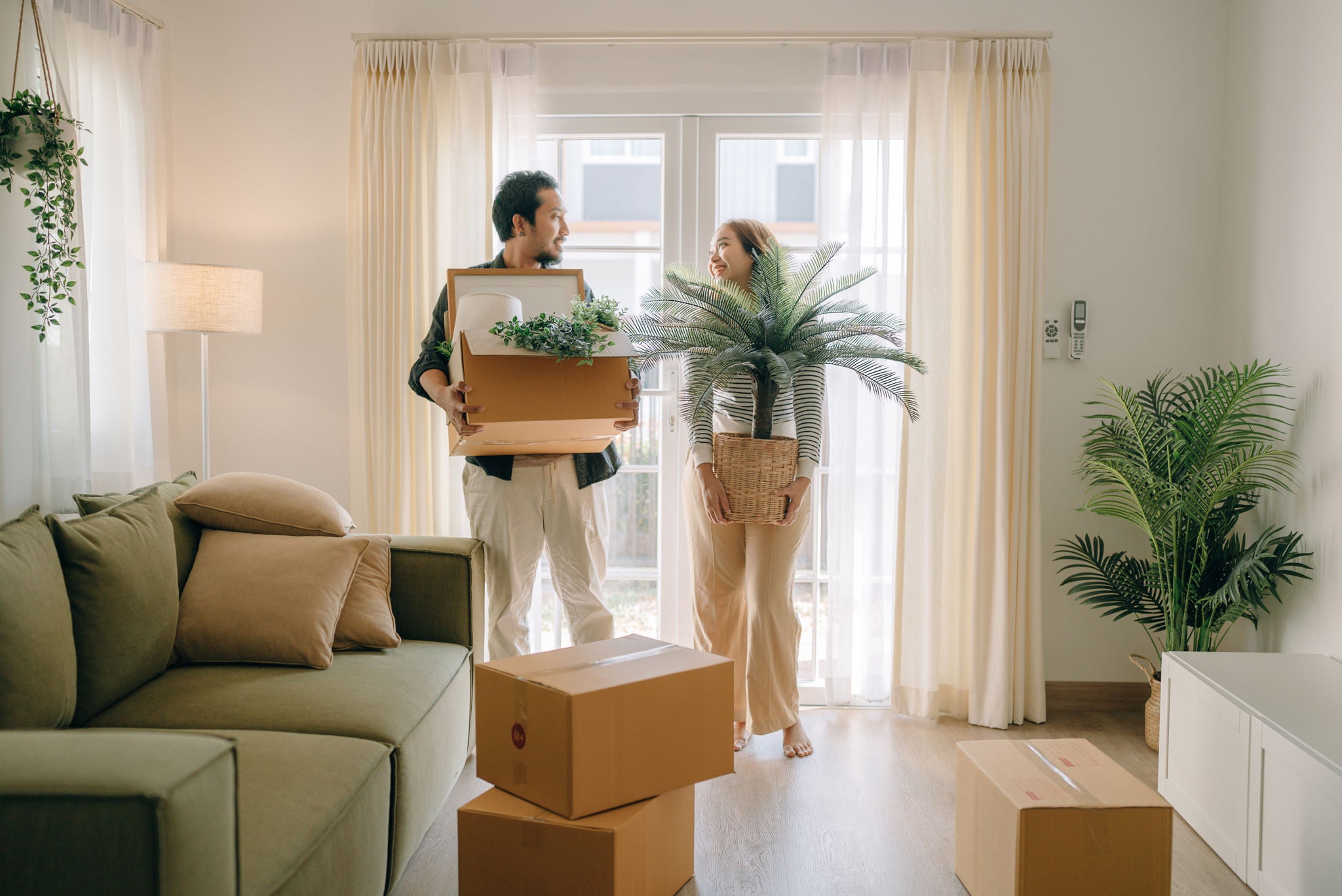 Asian couple moving new house for the new change in lives.